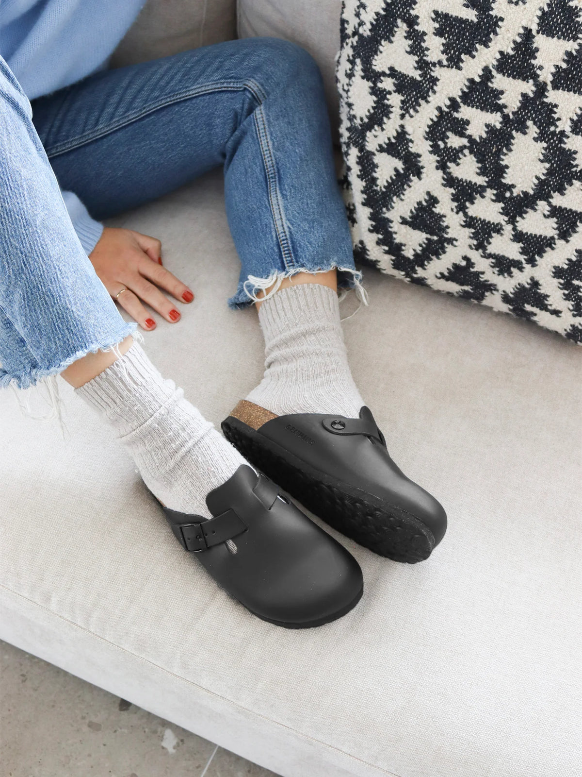 Genuins Riva clogs in black oiled leather, worn with white socks