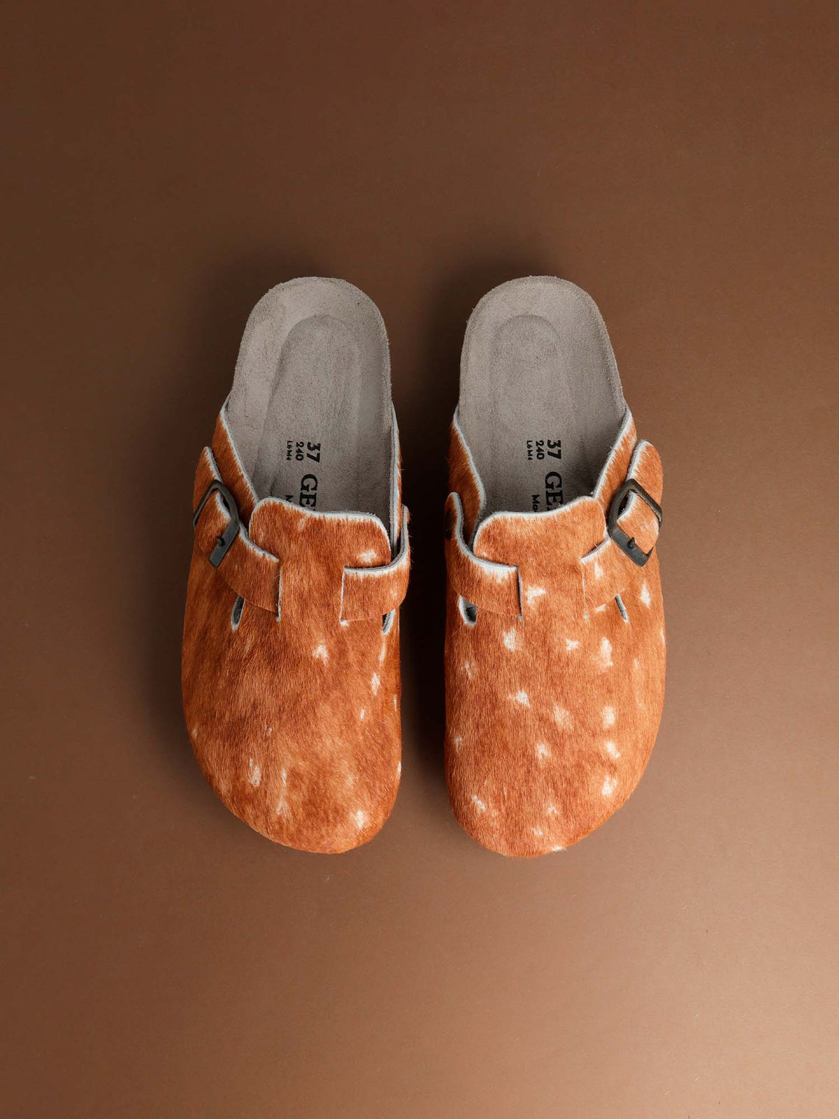 A pair of Genuins Riva clogs in a fawn print, seen from above